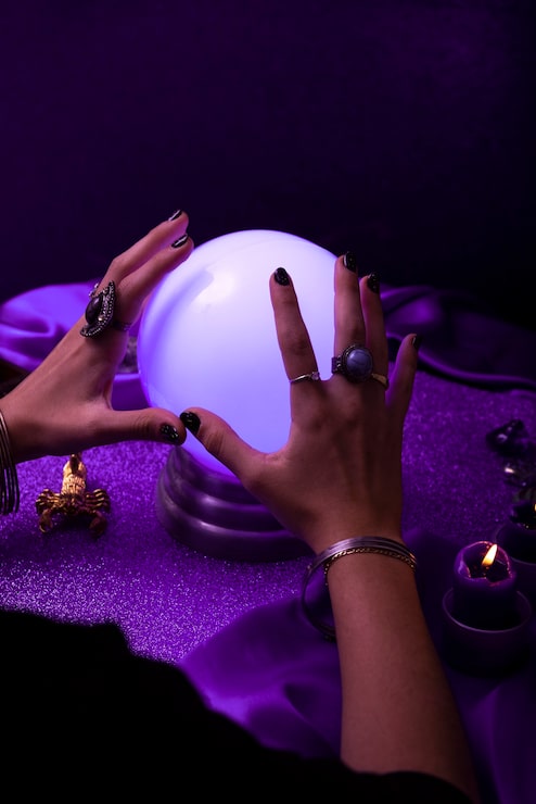 high-angle-hands-holding-crystal-ball