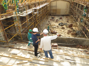 A client discussing construction aspects with a contractor on site.