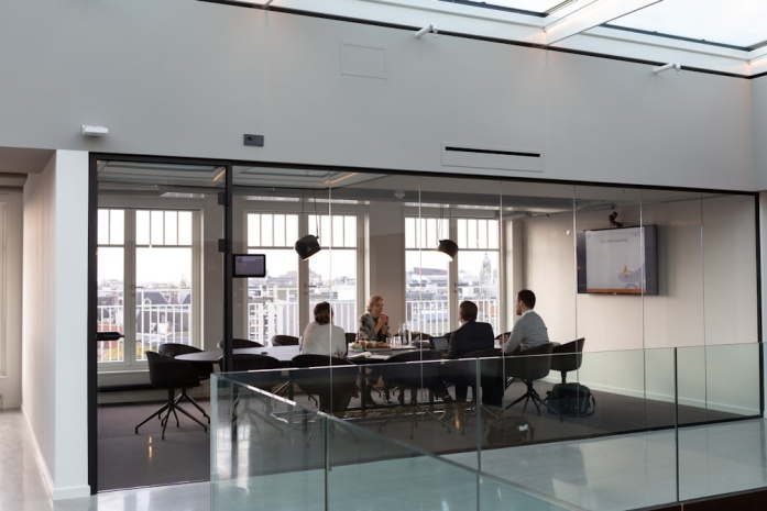 A group of colleagues having a business meeting in an office meeting room.