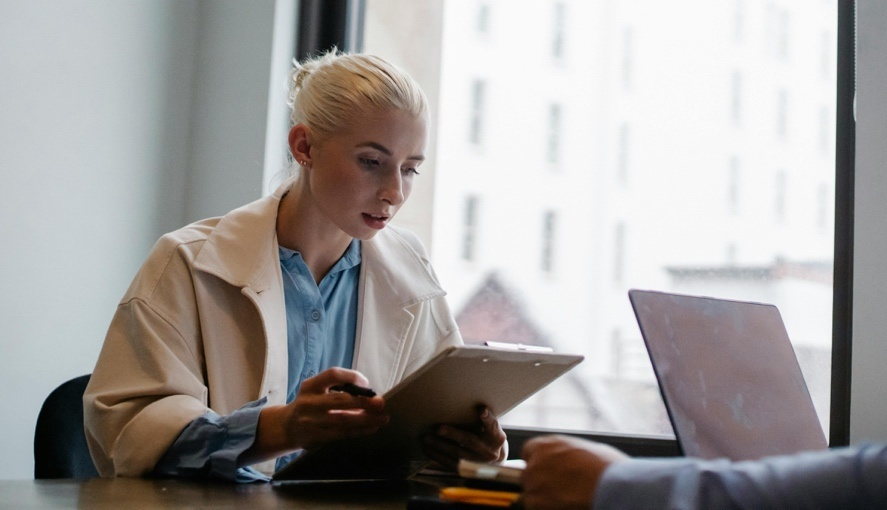 A woman reading a document at work