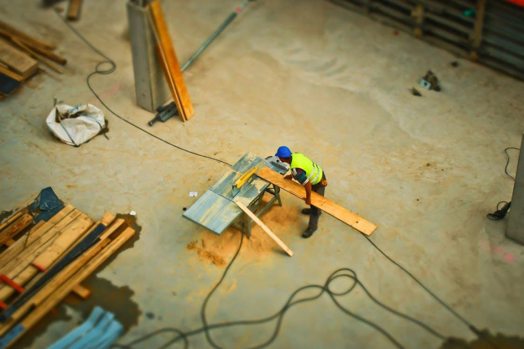 Working carrying a plank