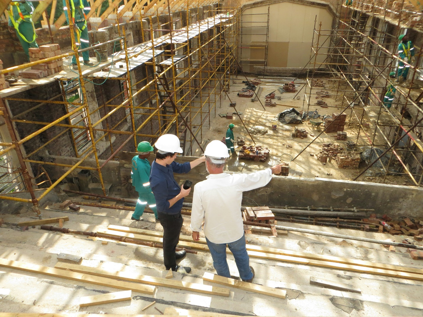 Two men engaged in conversation at a construction site