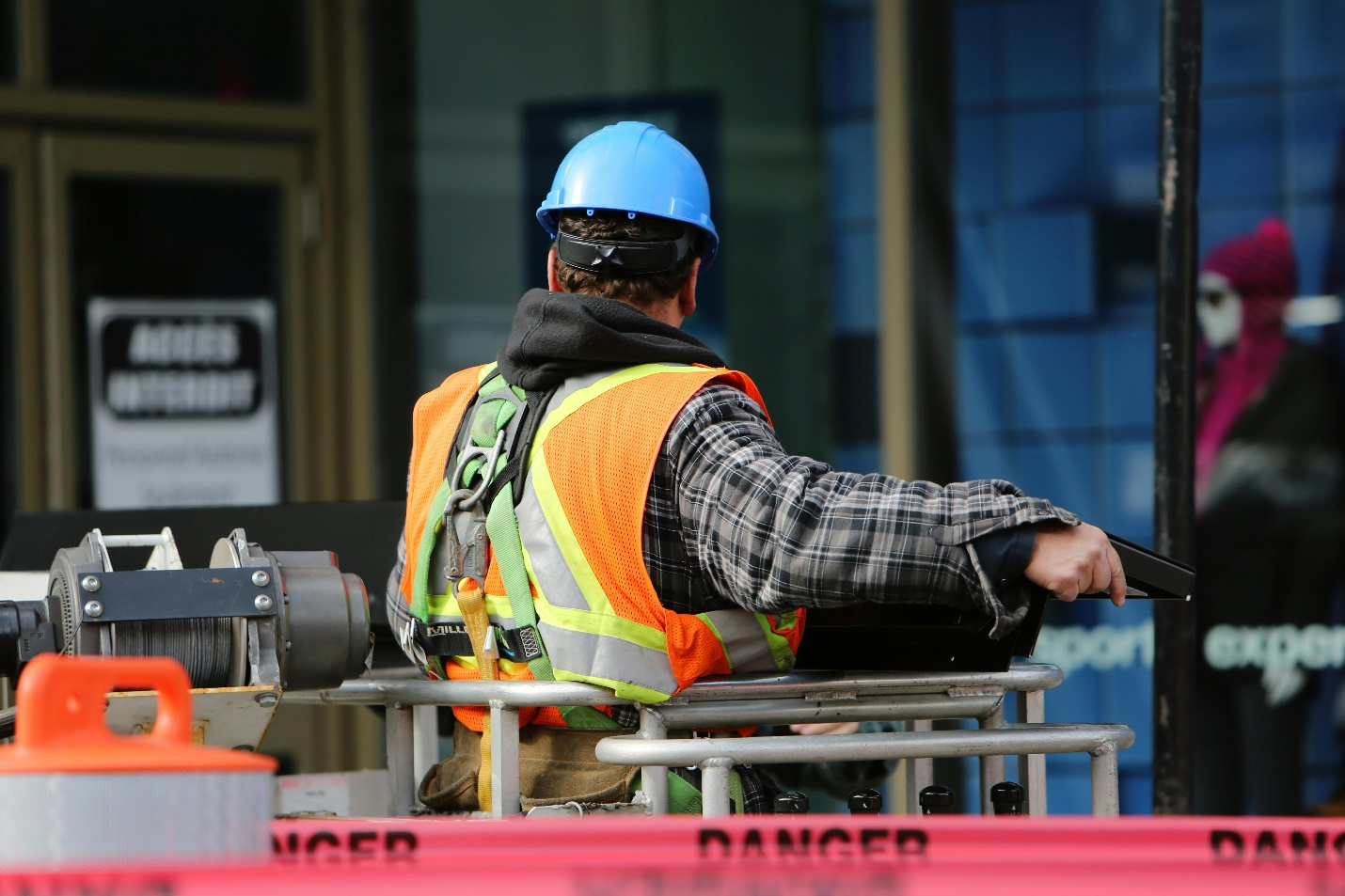 A man wearing a blue helmet at a construction site