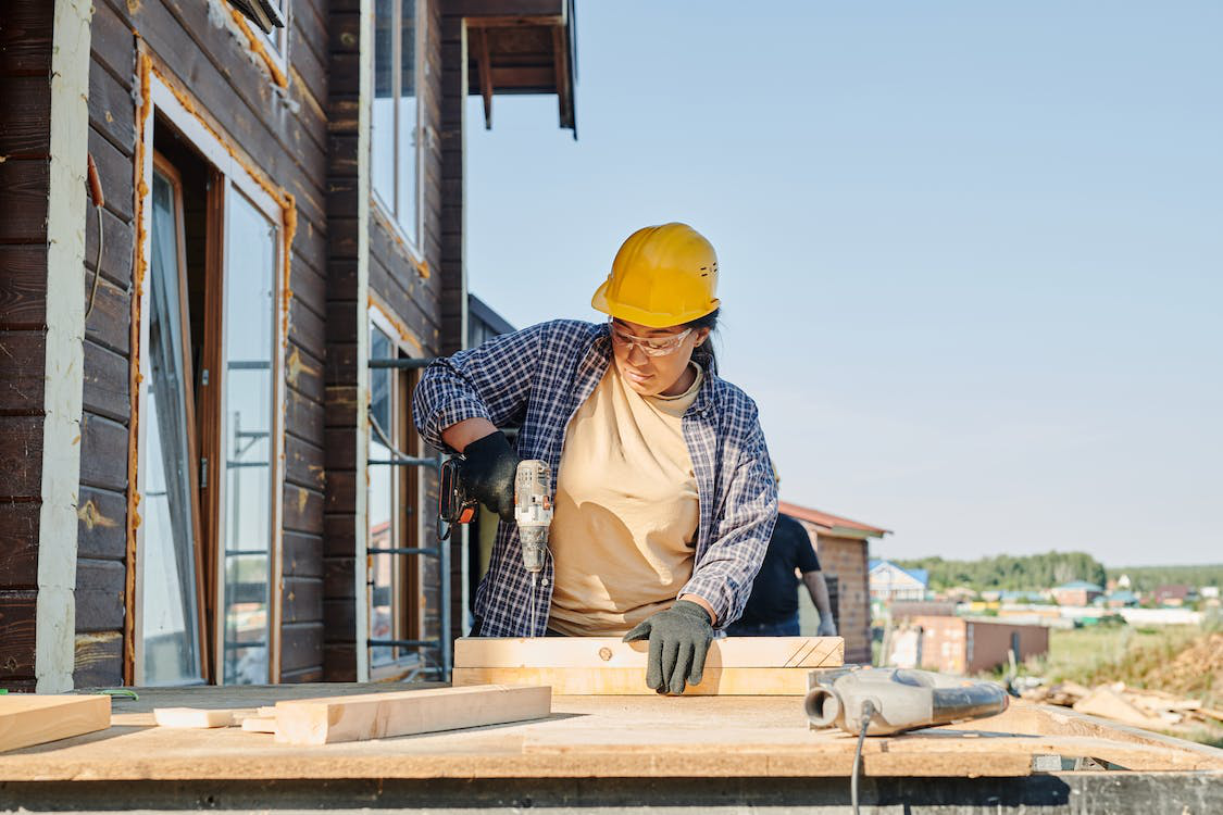 Woman wearing a hard hat working at a construction site