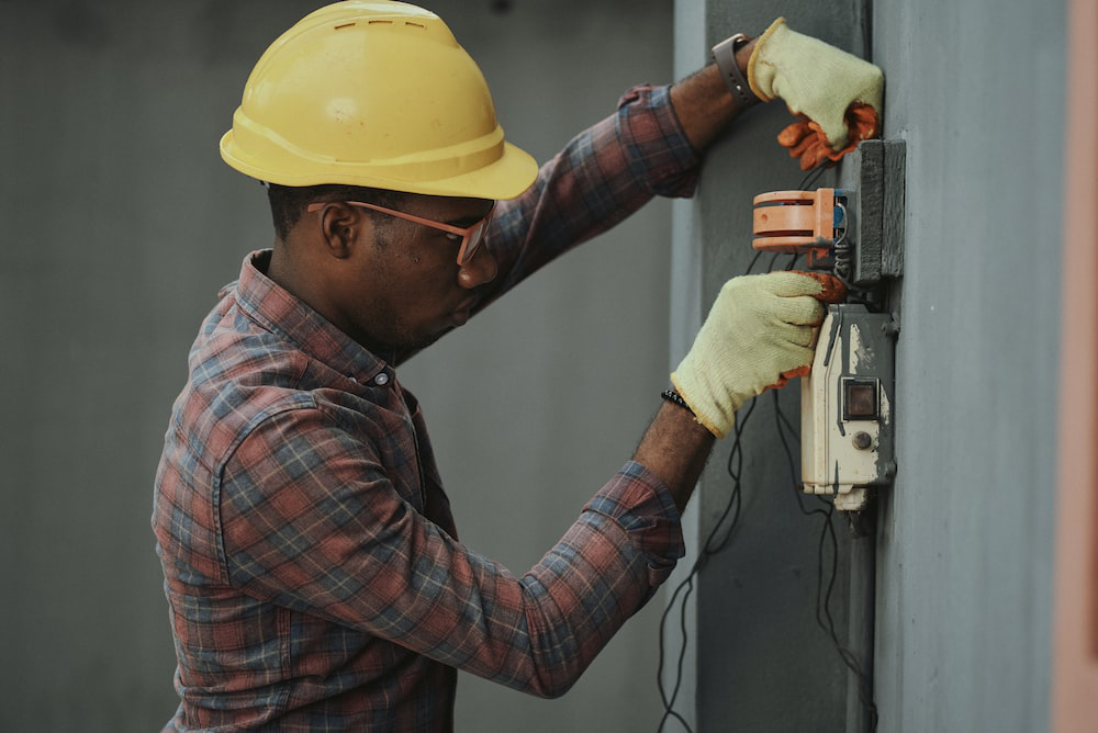 Man wearing a hard hat working at a construction site 