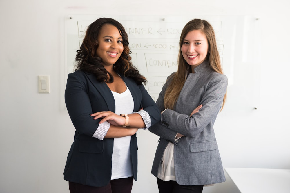 An image of two women in suits 